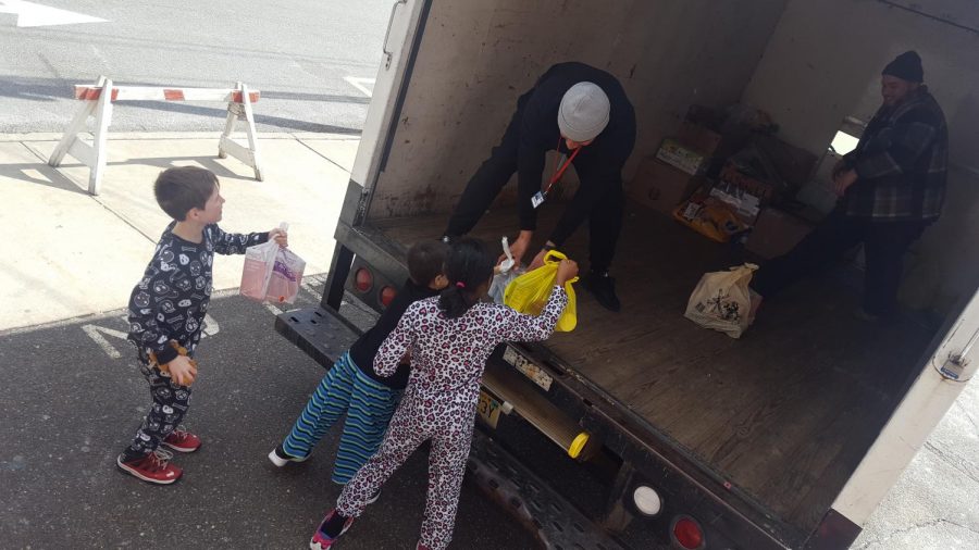 Third graders from Christina Knaacks homeroom help load canned goods onto the donation truck. The truck delivers the items to local food pantries.