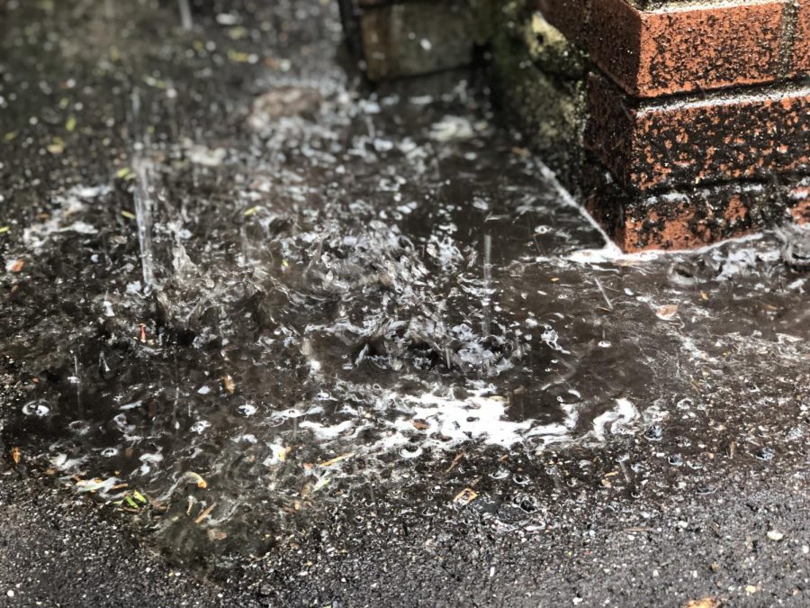 Water splashes onto the ground from a gutter at Patrick M. Villano School during a brief rain shower on May 31. The Emerson area is in for a rain-filled week ahead with mostly cloudy and overcast skies.