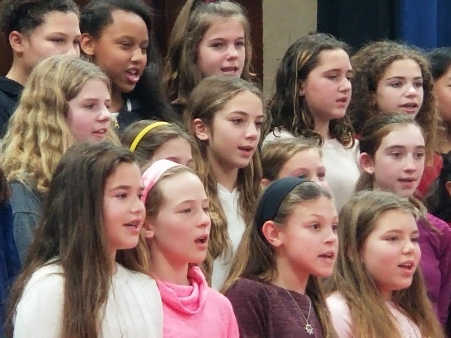 Members of the fifth and sixth grade chorus practice their songs on stage. Many of these students hope to continue singing in the middle school next year.