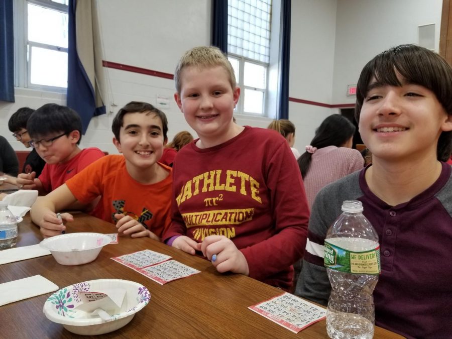 Thsi trio is listening for numbers between bites of ice cream. Many students said the sundae party was the perfect holiday treat.