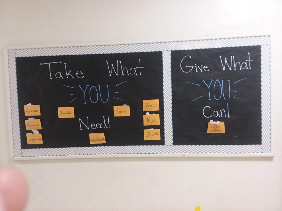 The new bulletin board in the main hallway of school is divided into two parts. On one side, students are asked to take what they need, and on the other, to give what they can.
