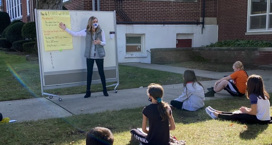 Taking advantage of the beautiful fall weather for a great outdoor lesson. Making it happen! is the caption on this school photo taken by Principal Jessica Espinoza.