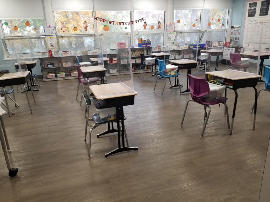 Plastic+barriers+separated+student+desks+which+were+placed+six-feet+apart+in+this+elementary+classroom+last+school+year.+Some+students+learned+virtually.+Now%2C+its+back+to+school+full-time+and+in-person+for+all.