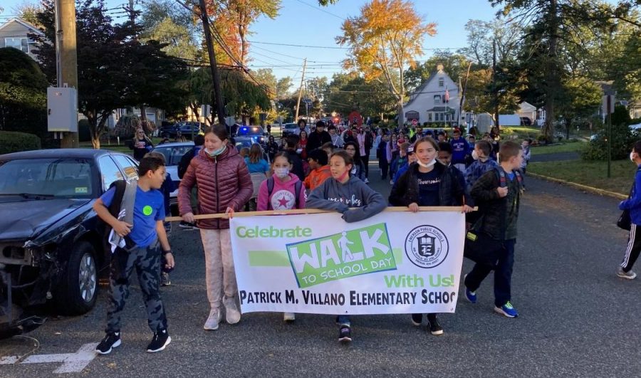 Students from Patrick m. Villano School hold a banner in honor of Walk to School Day. This is the first time Emerson participated in the outdoor community event.