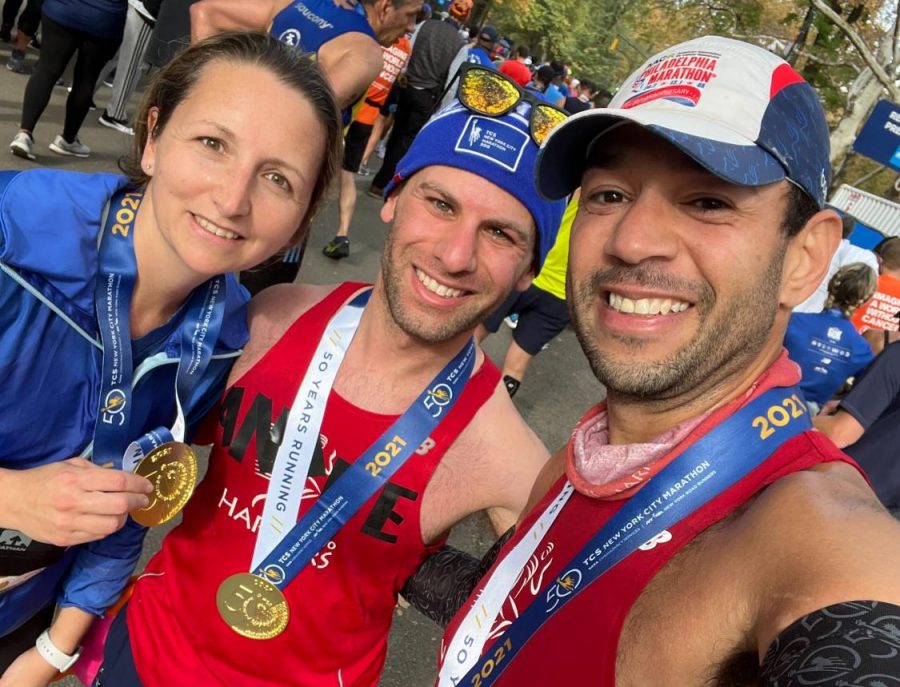 Andre Baruch, the school's band instructor, poses with friends after finishing the NYC marathon. It was his fourth marathon.