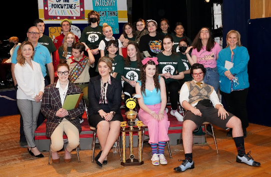 The cast of the high school play poses for a group photo.