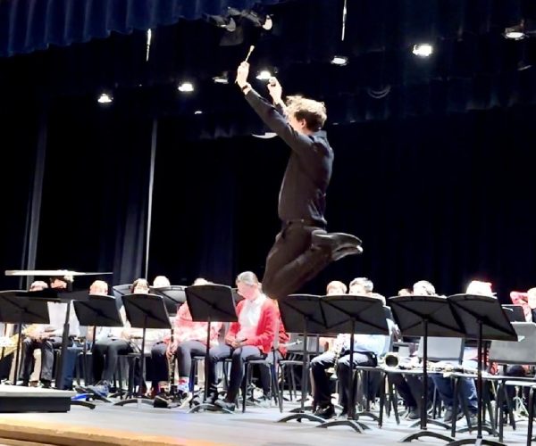 Joe Gibbs, the elementary band director, jumps following the symphonic band performance at Patrick M. Villano Schools annual winter concert.
