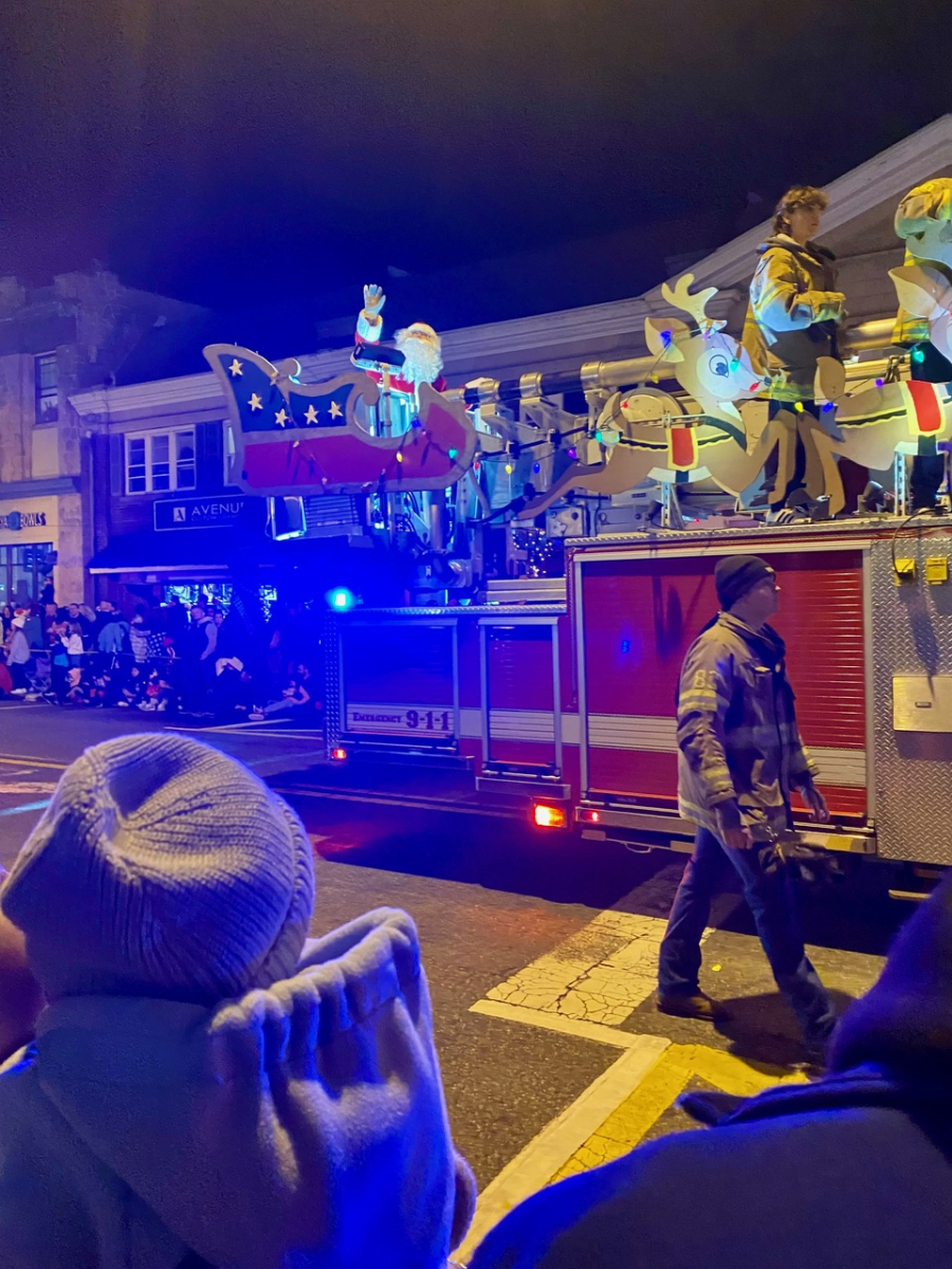 Santa waves to families as he passes by on his merry sleigh during the annual Home for the Holidays parade in Westwood, New Jersey.