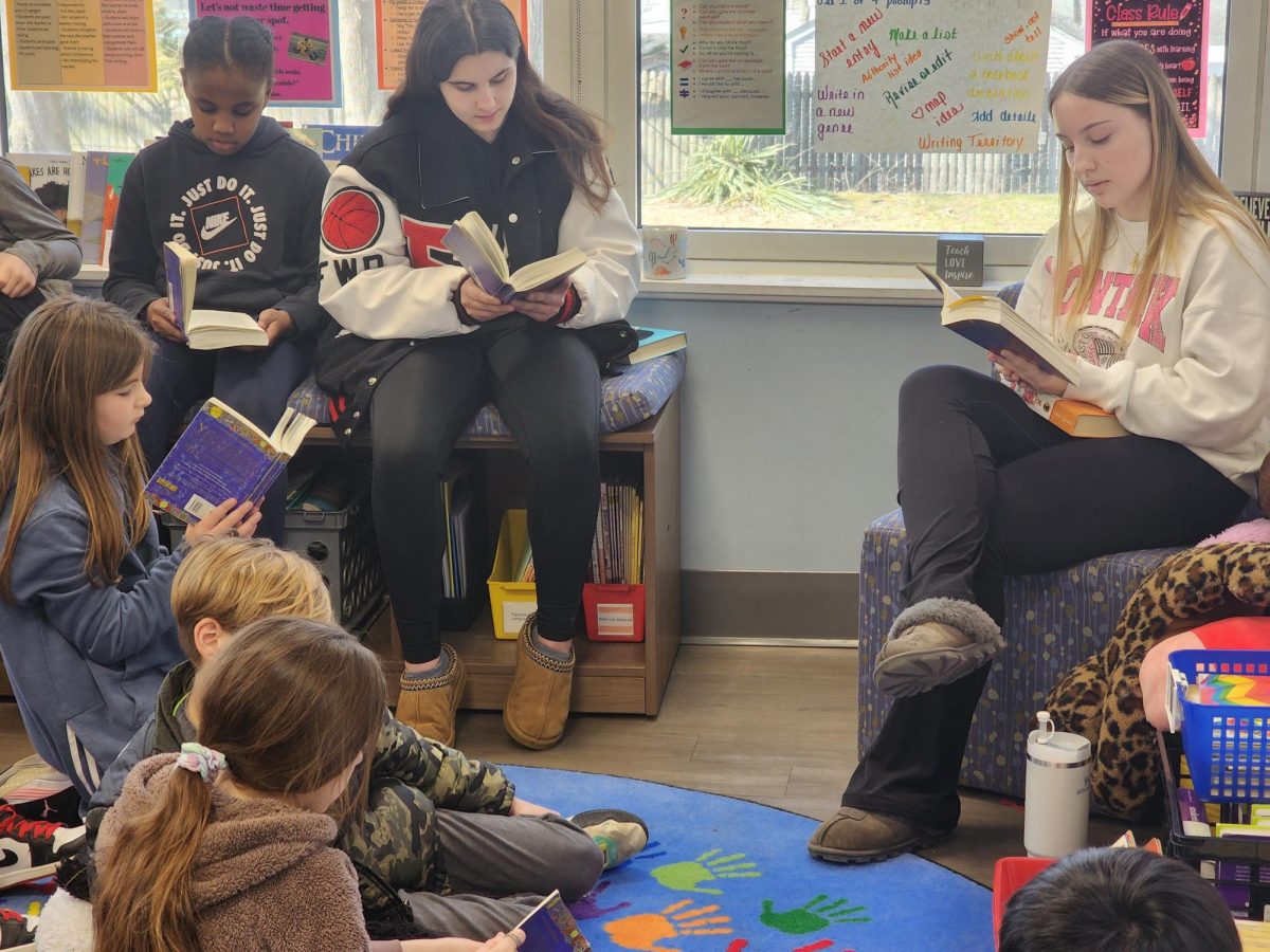 Members of the Key Club at Emerson Junior-Senior High School read to fourth graders in Mrs. Catuognos class.