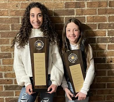 Triana Festa of Park Ridge and Alexa Palko of Emerson proudly hold their trophies. Both wrestlers placed at the recent state championship tournament in Trenton, New Jersey.