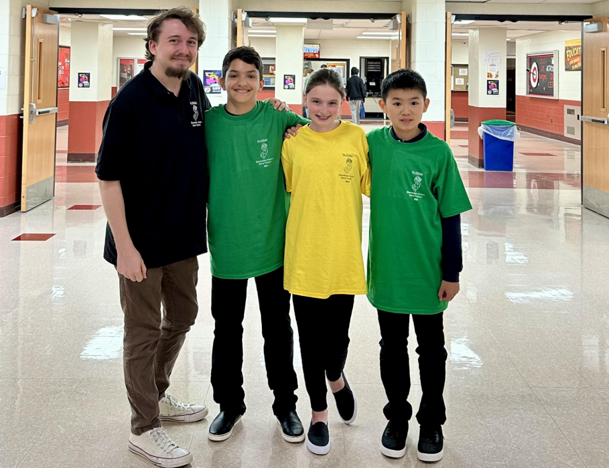 Students from Patrick M. Villano School pose with band instructor, Joseph Gibbs, between rehearsals.