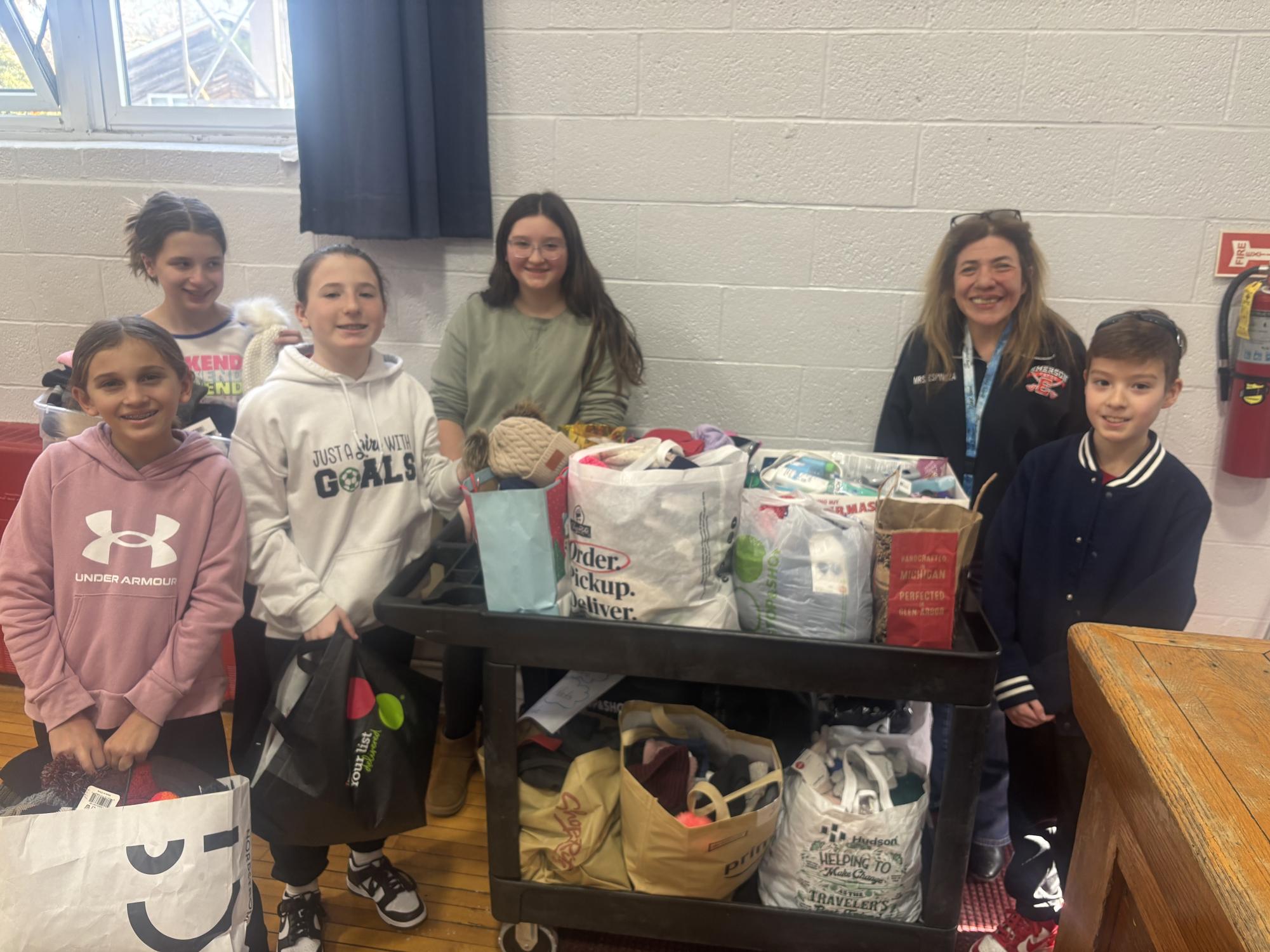 Sixth grade Student Congress members sort the more than 600 gloves, hats, and toiletries donated from Patrick M. Villano School.