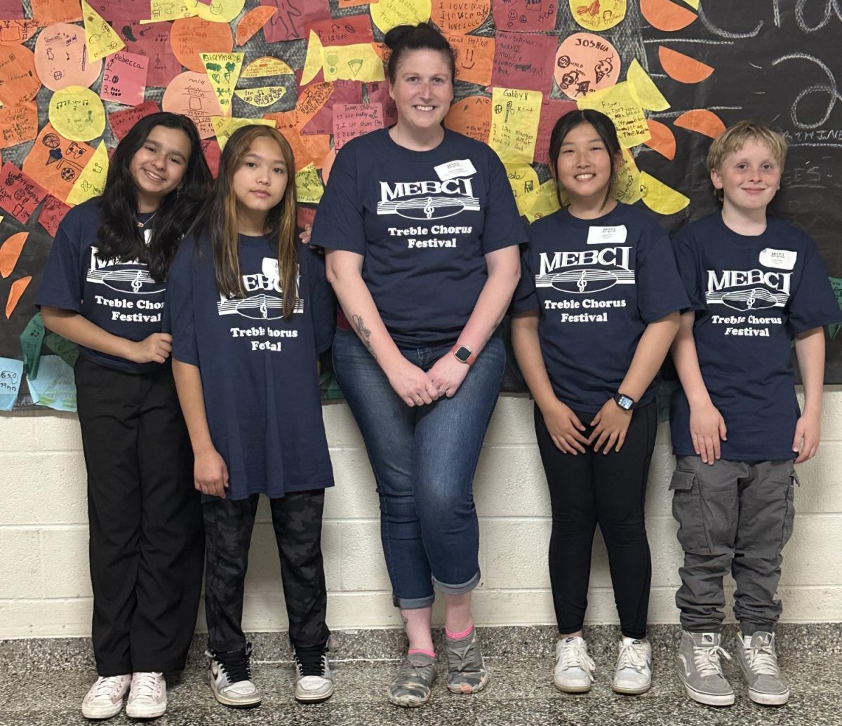 This photo features Allison Beckley, music instructor, and her students.