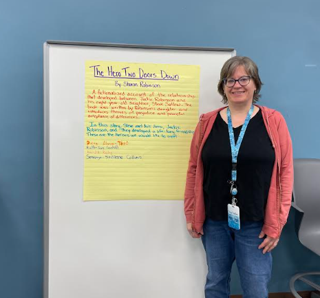 Cynthia Doran, fourth-grade teacher, leads the monthly book club talks. For each book, she creates a poster with main ideas from the book.