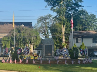 In Emerson, flowers are placed around this memorial for veterans in the center of the borough.