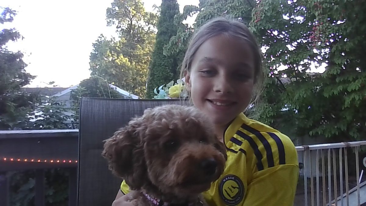 Angelica Lang poses with her pet dog. Lang is one of several students who love spending time with their four-legged friends.