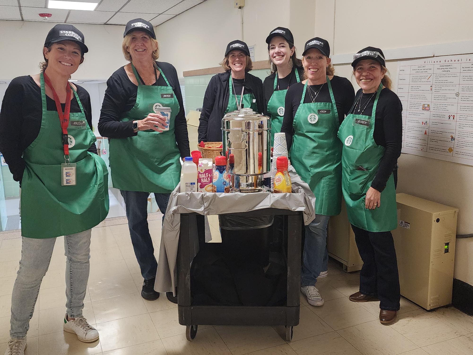 Principal Jessica Espinoza and some school staff members dressed as Starbucks baristas, or servers, with coffee and hot cocoa.