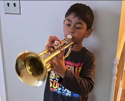 Ian Joy practices on the trumpet for beginner band. He enjoys its sound.