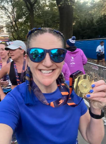 Colleen Malzahn ran the NYC marathon with her friend. Malzahn smiles at the finish line.