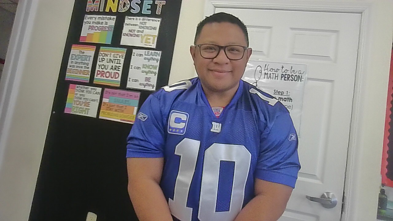 Kevin Dumlao sports a Giants jersey the Friday before the Super Bowl in his classroom. 