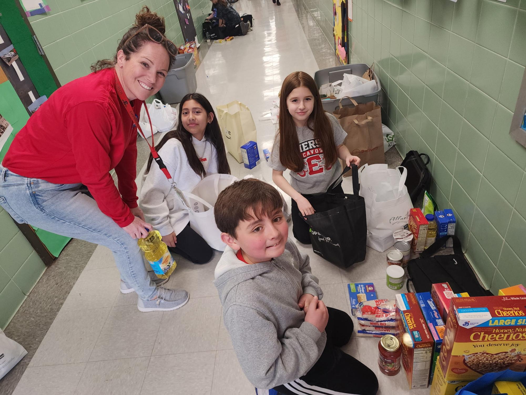 Kristy Friedman and Student Congress members sort through the hundreds of food items brought into school.