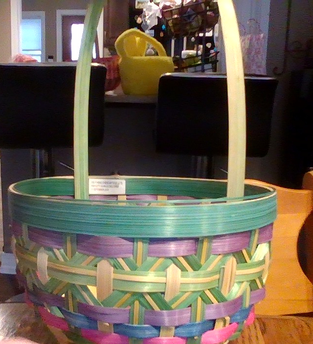 This is a traditional Easter basket. The basket is made out of wood and is colored green and yellow.