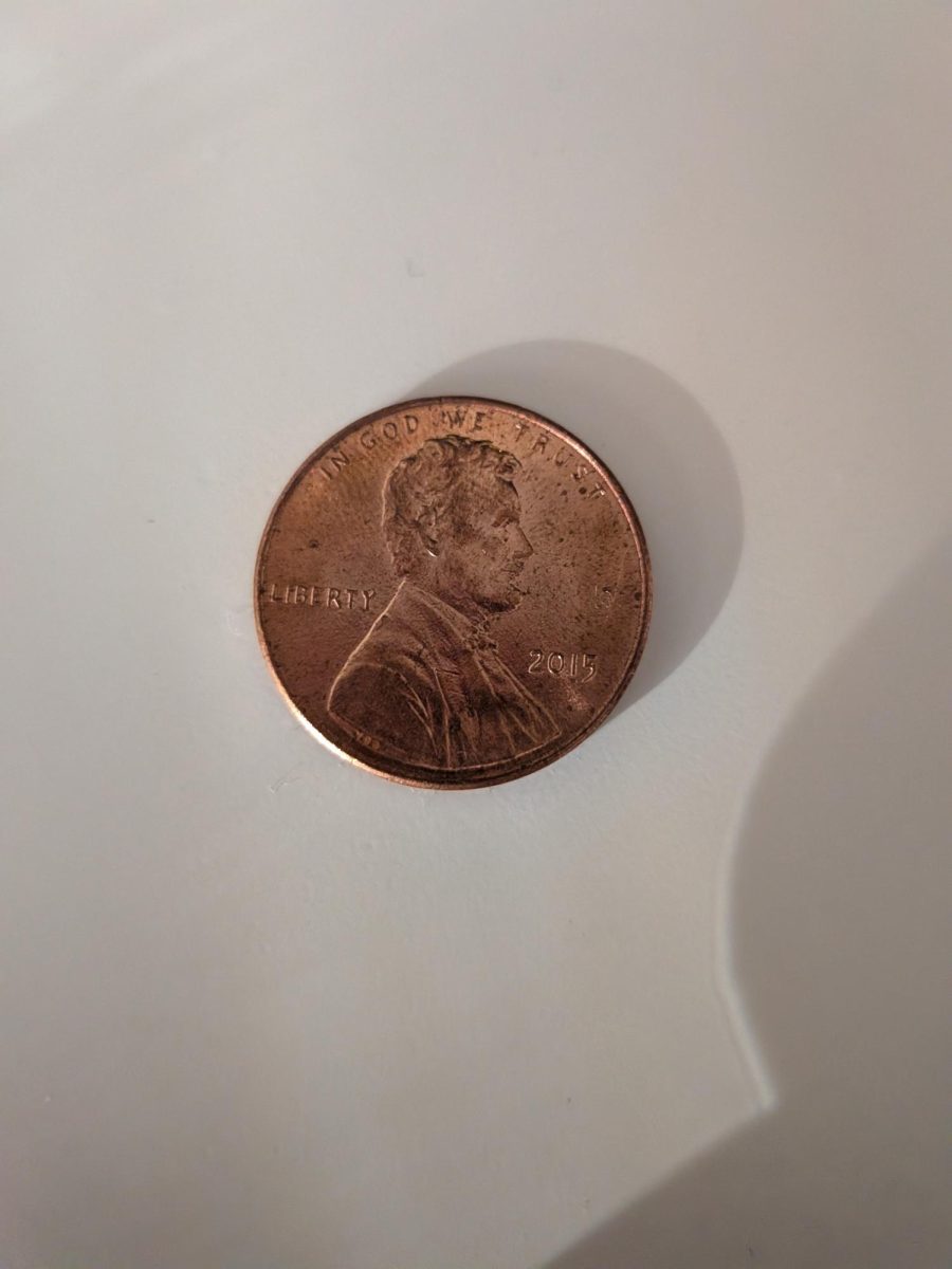 This is a penny minted in 2015. All pennies have an image of Abraham Lincoln, the 16th president of the United States, on the front.