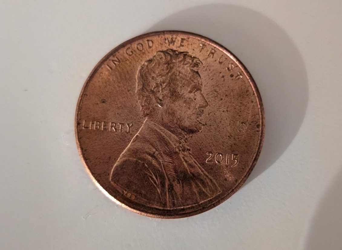 This is a penny minted in 2015. All pennies have an image of Abraham Lincoln, the 16th president of the United States, on the front.