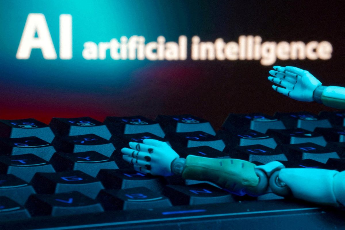 A message reading "AI artificial intelligence," a keyboard and robot hands are seen in this illustration created on January 27, 2025. REUTERS/Dado Ruvic/Illustration/